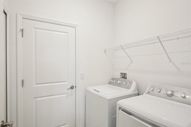 clothes washing area featuring laundry area and separate washer and dryer