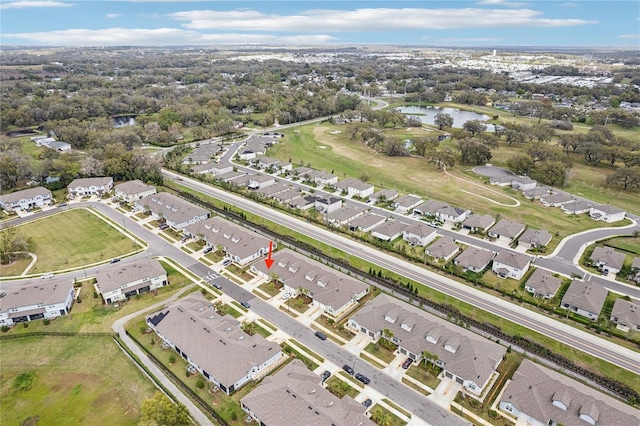 drone / aerial view featuring a residential view and a water view