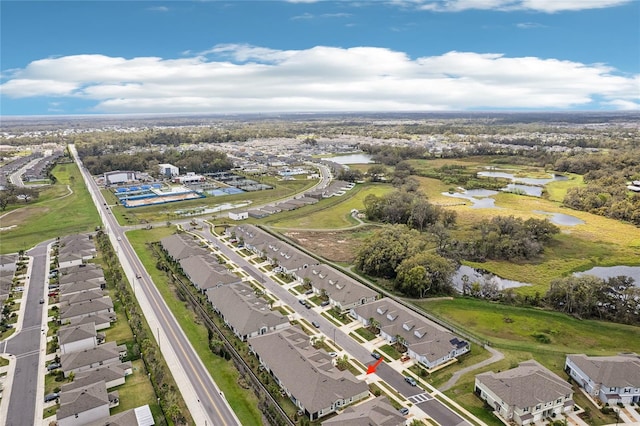 drone / aerial view featuring a water view and a residential view