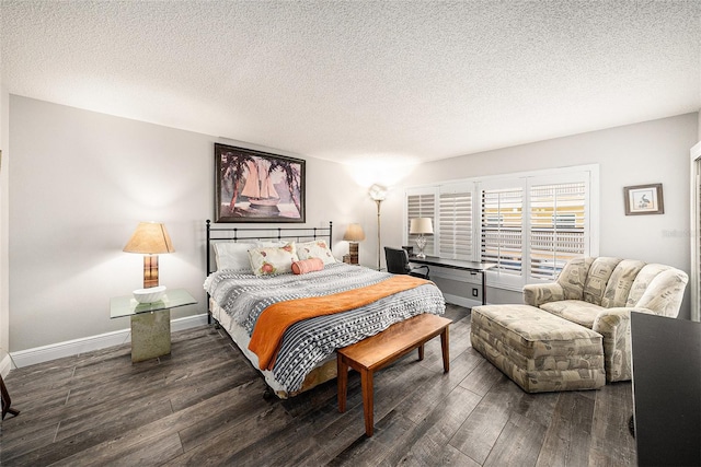 bedroom with wood finished floors, baseboards, and a textured ceiling