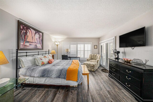 bedroom with wood finished floors, a closet, and a textured ceiling