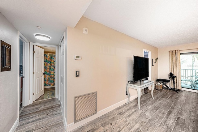 interior space featuring wood finished floors, visible vents, and baseboards