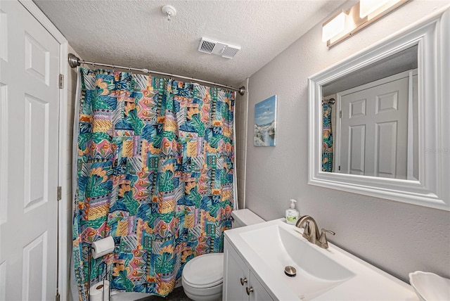 full bath with visible vents, toilet, vanity, a textured wall, and a textured ceiling