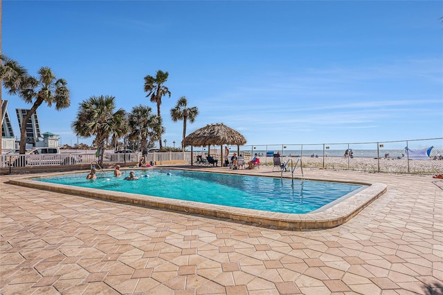 pool featuring a gazebo, a patio area, and fence