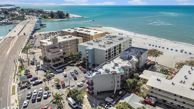 drone / aerial view featuring a water view and a beach view