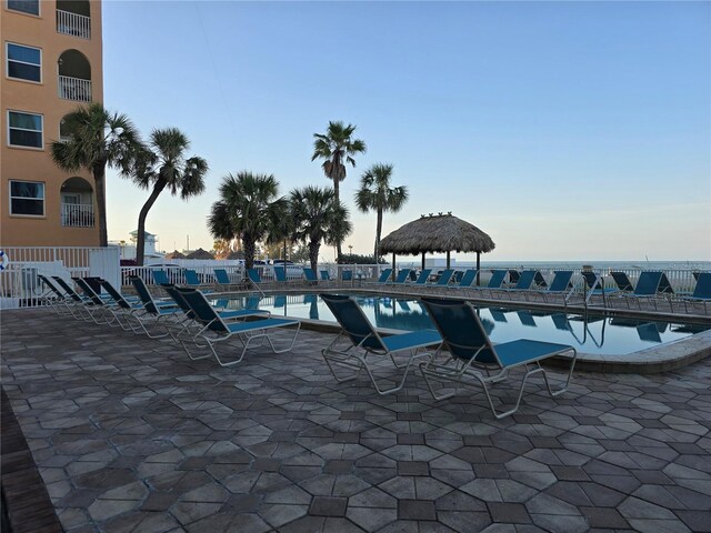 12924 Gulf Blvd Unit 110, Saint Petersburg, FL 33708 - pool at dusk with a community pool and a patio area