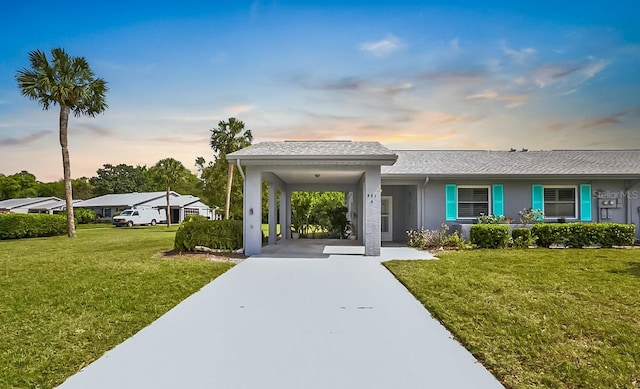 view of front of house featuring a front yard, driveway, and stucco siding