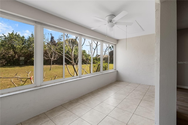 unfurnished sunroom featuring a ceiling fan