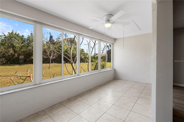 unfurnished sunroom featuring ceiling fan