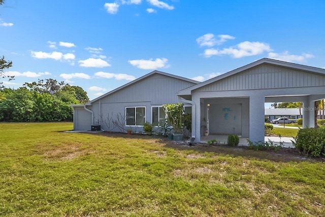 view of front of home with a front yard and central AC unit