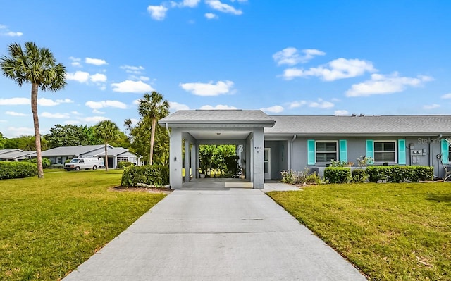 view of front of home featuring concrete driveway, a front lawn, an attached carport, and stucco siding