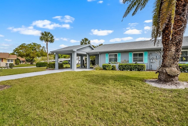 view of front of home with an attached carport, a front lawn, and stucco siding