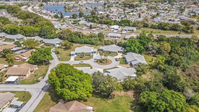 drone / aerial view with a water view and a residential view