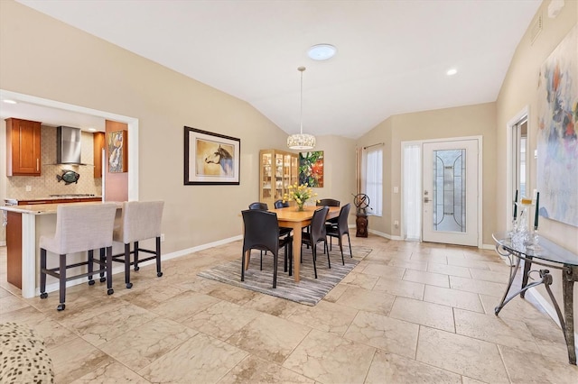 dining room with lofted ceiling, visible vents, and baseboards