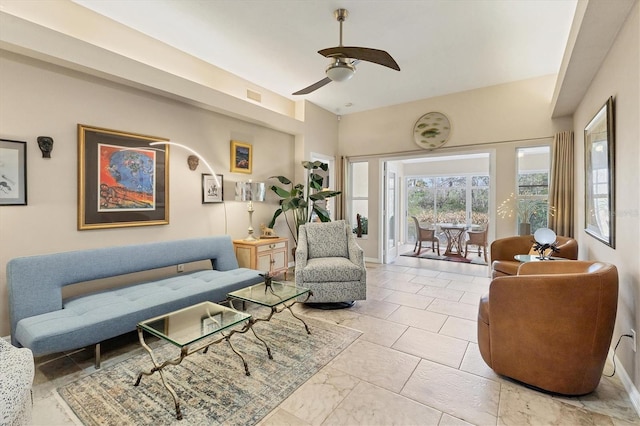 living area featuring a ceiling fan, visible vents, and baseboards