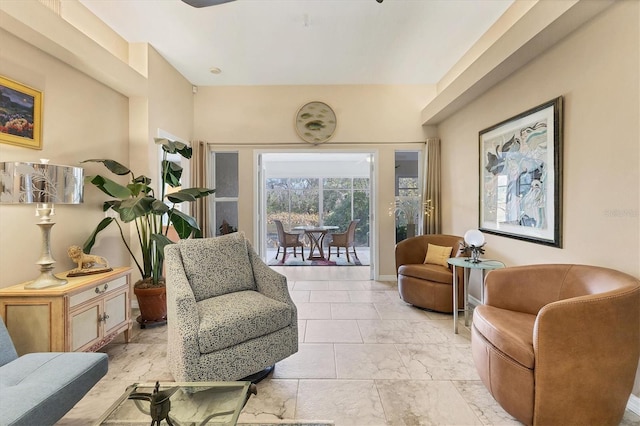 sitting room featuring marble finish floor