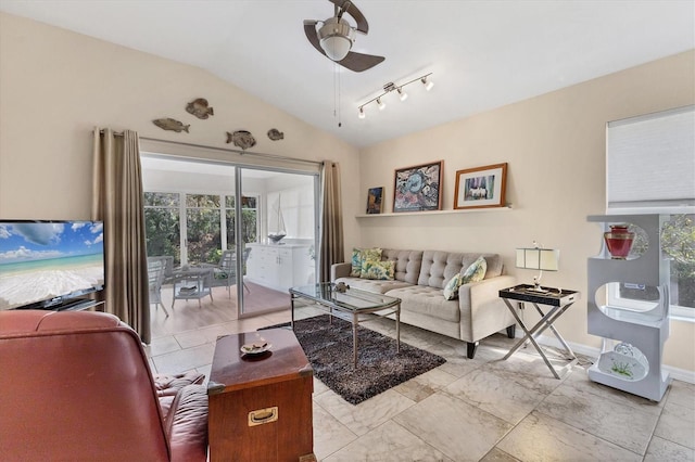 living area featuring lofted ceiling, a ceiling fan, and baseboards