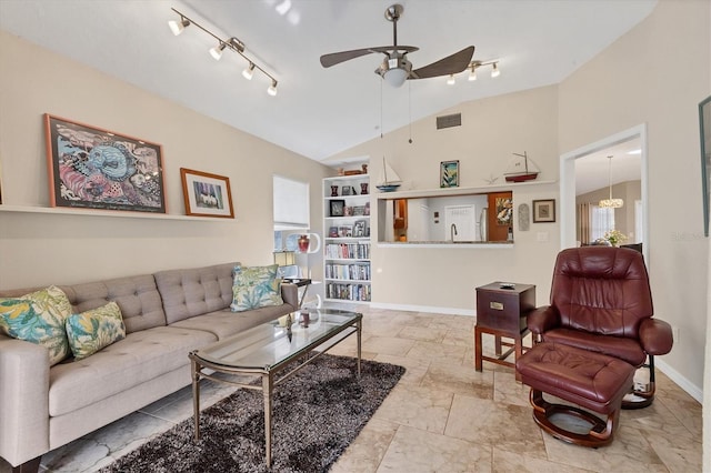 living area featuring lofted ceiling, ceiling fan, visible vents, baseboards, and track lighting