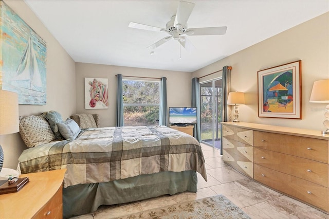 bedroom with access to exterior and a ceiling fan