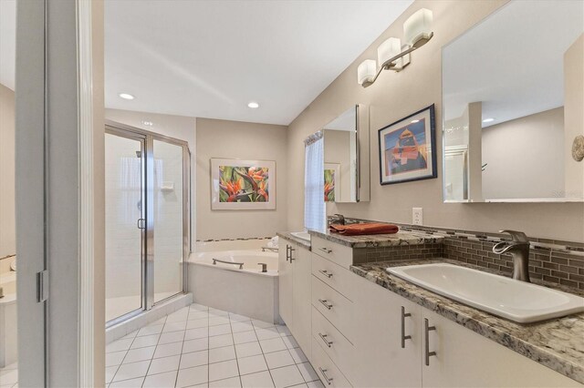 bathroom featuring tasteful backsplash, a stall shower, vanity, tile patterned flooring, and a bath