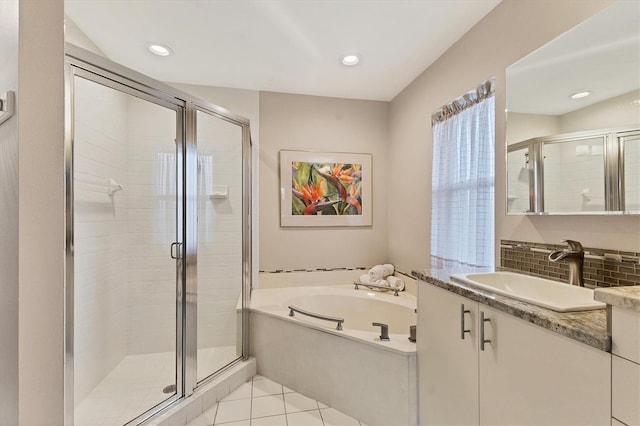 bathroom featuring recessed lighting, a stall shower, vanity, tile patterned flooring, and a bath