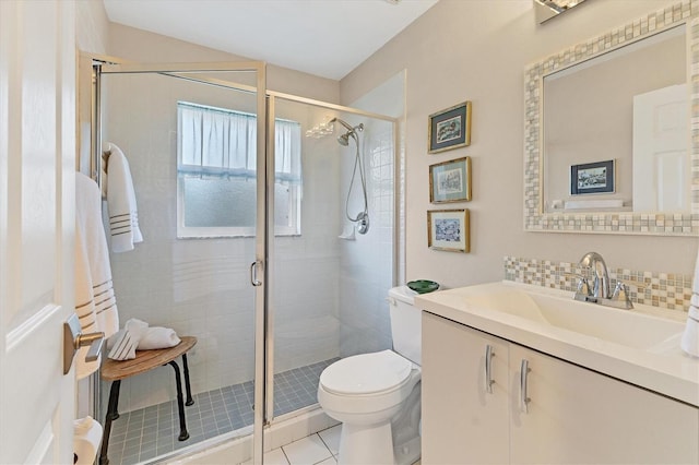 full bath with toilet, vanity, backsplash, tile patterned floors, and a stall shower