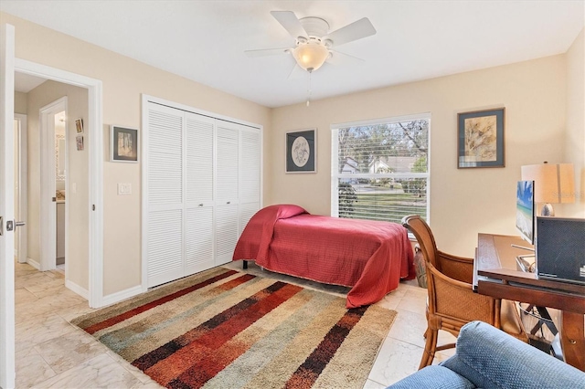 bedroom featuring ceiling fan, a closet, and baseboards