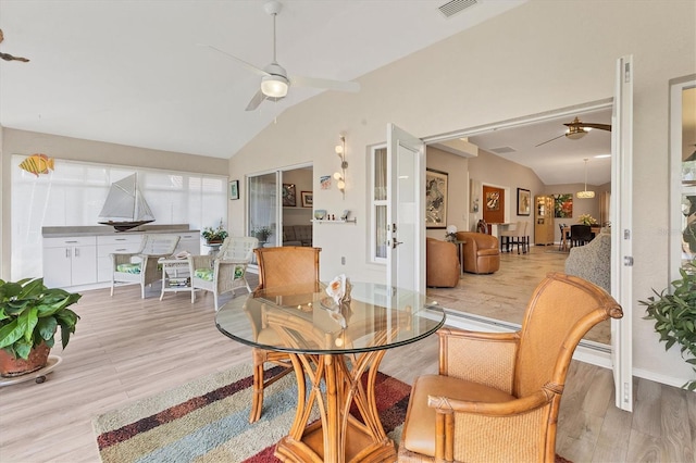 dining area with lofted ceiling, ceiling fan, and wood finished floors