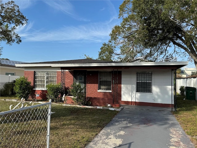 ranch-style home featuring brick siding, a front yard, and fence