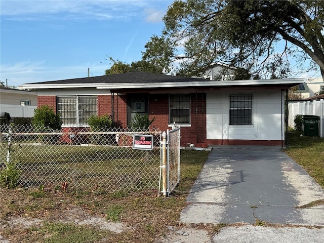 view of front facade featuring fence private yard, brick siding, and a front yard