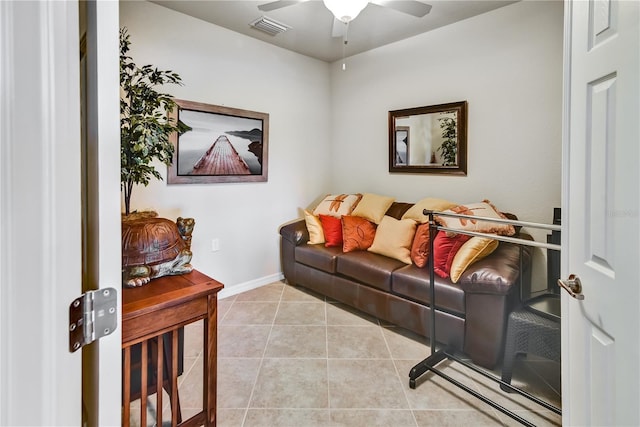 living area with light tile patterned floors, baseboards, visible vents, and a ceiling fan