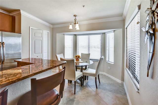 dining area with ornamental molding, a notable chandelier, baseboards, and light tile patterned floors