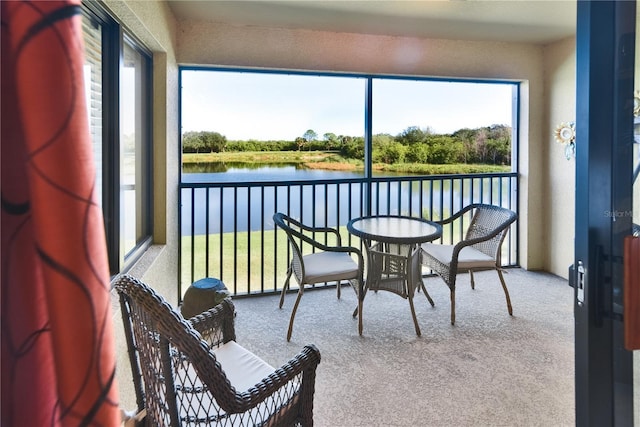 balcony featuring a water view