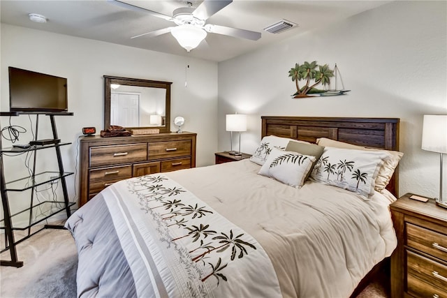 bedroom featuring visible vents, ceiling fan, and light carpet