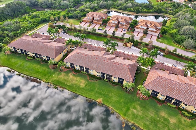 drone / aerial view featuring a residential view and a water view