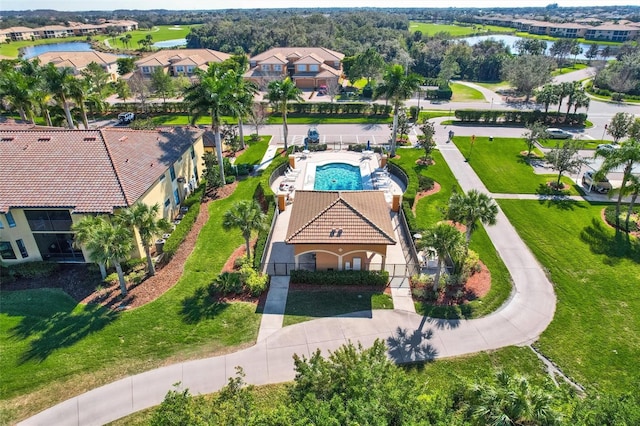 drone / aerial view featuring a water view and a residential view