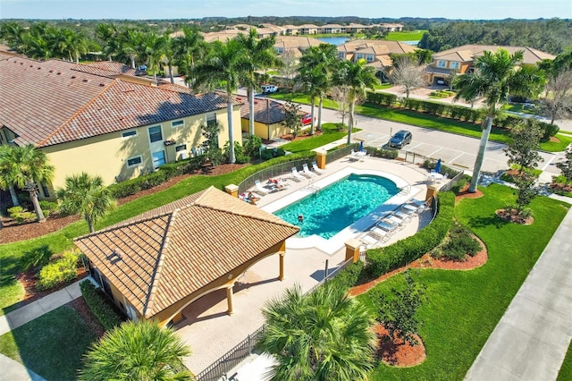 pool featuring a patio, fence, and a residential view