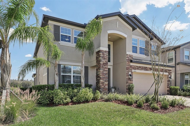 view of front of property with a garage, driveway, a front lawn, and stucco siding