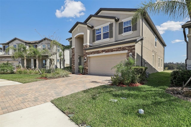 view of front of home featuring a garage, a front lawn, decorative driveway, and stucco siding