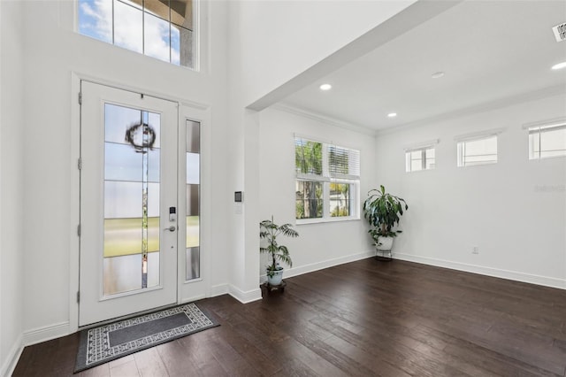 foyer featuring recessed lighting, visible vents, baseboards, wood-type flooring, and crown molding