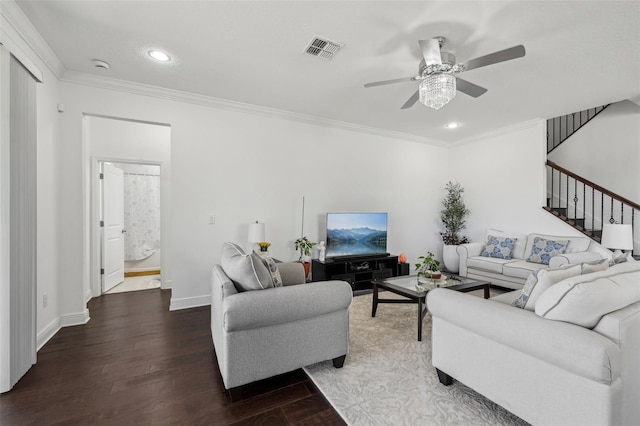 living area with visible vents, crown molding, baseboards, and wood finished floors