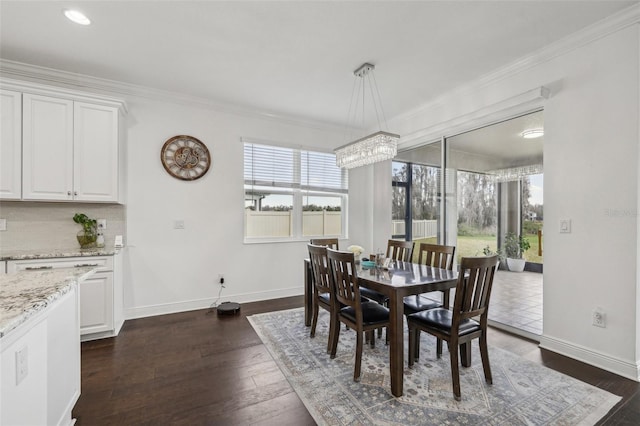 dining area featuring baseboards, dark wood-type flooring, and crown molding