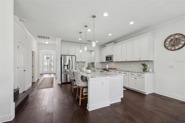 kitchen with stainless steel appliances, ornamental molding, a sink, and white cabinetry