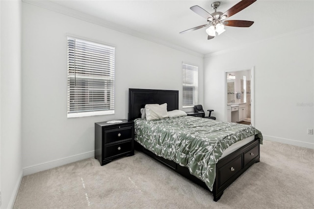 bedroom featuring baseboards, ornamental molding, connected bathroom, and light colored carpet