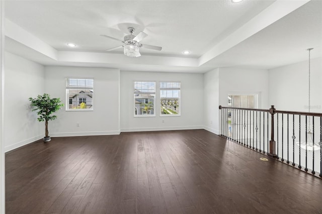 empty room featuring dark wood-style floors, recessed lighting, baseboards, and a ceiling fan