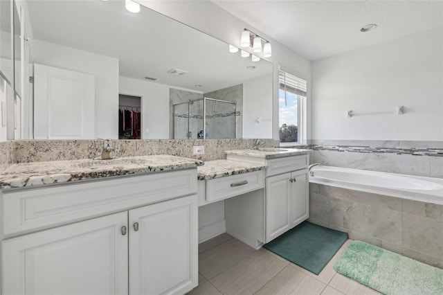 full bath with a stall shower, visible vents, tile patterned floors, a garden tub, and vanity