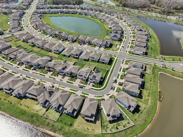 bird's eye view with a water view and a residential view