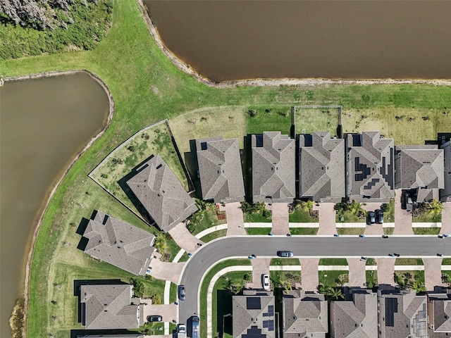 drone / aerial view featuring a water view and a residential view