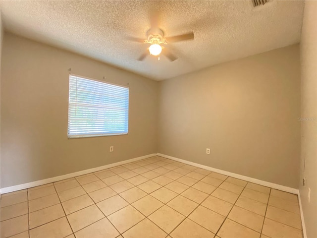 unfurnished room featuring light tile patterned flooring, a textured ceiling, baseboards, and a ceiling fan