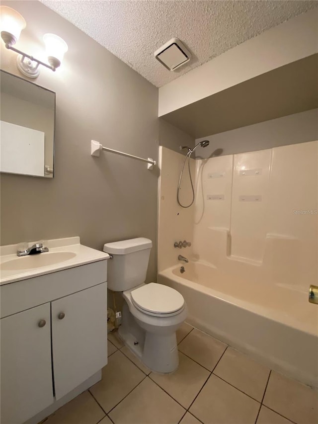 full bath featuring tile patterned floors, toilet, a textured ceiling, bathtub / shower combination, and vanity